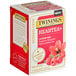 A box of Twinings Superblends Heartea+ Raspberry Hibiscus Herbal Tea Bags with a red and white label.