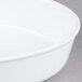 A close-up of a white oval deep dish porcelain serving platter.