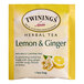 A yellow and white box of Twinings Lemon & Ginger Herbal Tea Bags.