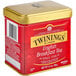 A red and gold Twinings English Breakfast tea tin with a lid.