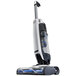 A Hoover ONEPWR Evolve cordless upright vacuum cleaner with a blue and silver handle.