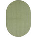 A close-up of a green oval rug with white accents.