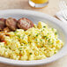 A plate of Papetti's fully cooked scrambled eggs with sausage.