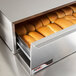 An APW Wyott metal box bun warmer with buns inside.