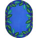 A blue oval rug with green leaves on it.
