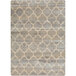 A close up of a Joy Carpets First Take Antique Trellis area rug with a beige and grey geometric pattern.