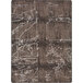 A close-up of a Joy Carpets Umber area rug with an abstract design in brown and white with a crack in the middle.