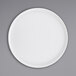 A white Cal-Mil melamine plate with a low circular rim.