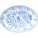 A white oval melamine platter with blue and white painted floral designs.
