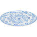 A close-up of a Cal-Mil Costa blue and white melamine plate with a floral design.