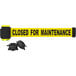 A black and yellow Banner Stakes wall mount barrier with yellow and black tape with black text.