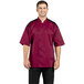 A man wearing a burgundy Uncommon Chef Rogue Pro Vent short sleeve chef coat with mesh back.