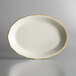 A white oval china platter with gold trim.