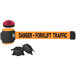 An orange and black Banner Stakes wall mount barrier with a red light on top.