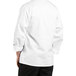 A person wearing an Uncommon Chef white long sleeve chef coat with black stripes.