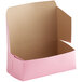 A pink Baker's Mark donut box with the lid open.