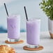 Two glasses of Bossen Taro Milk Tea with purple liquid and straws.