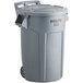 A grey Rubbermaid BRUTE trash can with wheels and a lid.