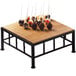 A Cal-Mil iron black square riser with a bamboo top on a wooden table with cake pops on skewers.