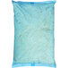 A blue plastic bag of Kraft Shredded Parmesan Cheese with white shredded cheese inside.