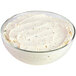 A bowl of Boursin garlic and fine herb gournay cheese with a white background.