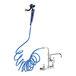 A Waterloo pet grooming faucet with a blue coiled hose attached to the faucet.
