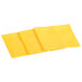 Several slices of Kraft sharp cheddar cheese on a white background.