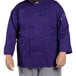 A man wearing a Uncommon Chef Orleans purple long sleeve chef coat.