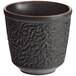 A black Acopa stoneware mug with a textured surface.