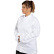 A woman in a white Uncommon Chef long sleeve chef coat.