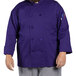 A man wearing a grape Uncommon Chef long sleeve chef coat.