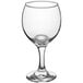An Acopa clear wine glass on a white background.