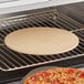 A pizza on the American Metalcraft pizza stone in an oven.