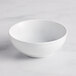 An Acopa Capri coconut white stoneware nappie bowl with a curved edge.