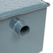 A close-up of a gray metal Watts WD-7 grease trap box with a pipe.