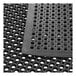 A Choice black rubber anti-fatigue floor mat with beveled edges and holes.