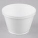 A white styrofoam food container with a lid.
