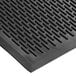A close-up of a black rubber Choice Ridge-Scraper Top safety mat with a patterned design.