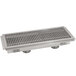 A stainless steel Advance Tabco floor trough grate over a drain.