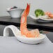 An Arcoroc appetizer spoon with shrimp and broccoli on it.