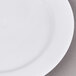 A close up of an Arcoroc white porcelain B&B plate with a white rim.