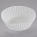 A close up of a white fluted baking cup.