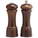 Two brown wooden salt and pepper mills with round bases and handles.