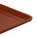 A close-up of a brown Cambro dietary tray.