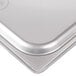 A stainless steel slotted steam table pan cover.