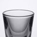 A close-up of a Libbey shot glass with a black rim.