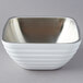 A Vollrath pearl white metal beehive serving bowl with a silver rim.