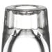 A close-up of a clear Libbey fluted shot glass on a table.