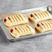Bridor strawberry cream cheese danish pastry rolls on a tray.