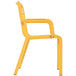 A yellow plastic Grosfillex outdoor armchair with armrests.